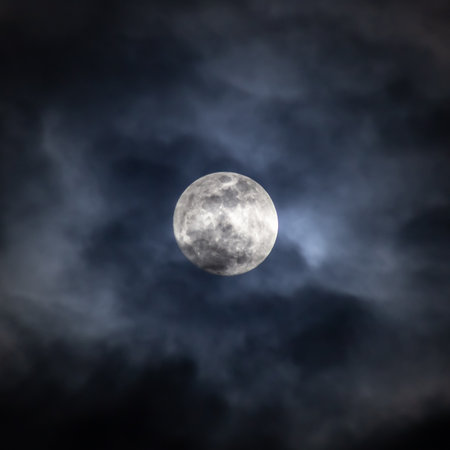 Full moon in the night sky with dark clouds. Elements of this image furnished by NASAの写真素材