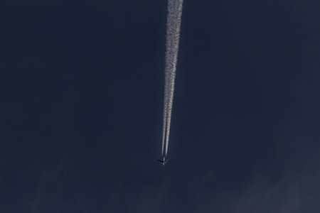 Aerial view of a plane flying in the blue sky in the clouds