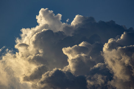 Dramatic cloudscape with dark blue sky and white fluffy clouds