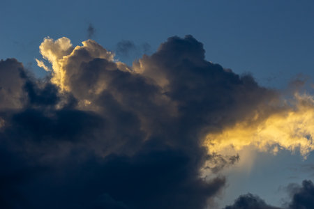 Cloudscape, Colored Clouds at Sunset near the Ocean with a Golden Lightの写真素材