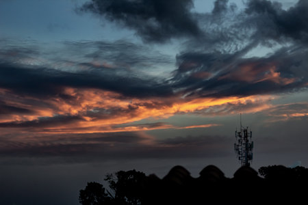 Silhouette of telecommunication tower and cloud with sunset sky.の写真素材