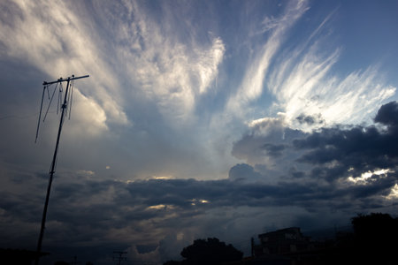 Stormy sky with cloud and sunbeam over the city in Thailandの写真素材