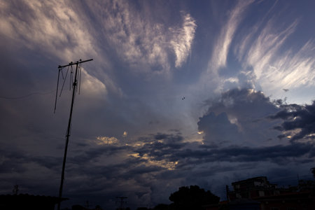 Clouds in the sky and the silhouette of a poleの写真素材