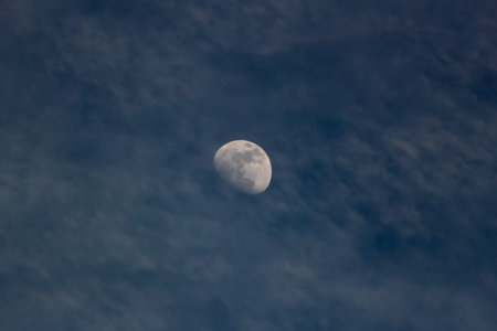 Moon in the sky with clouds in the evening, closeup