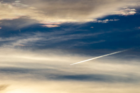 blue sky with cloud closeup and airplane trail, nature series.の写真素材