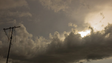 Dramatic sky with stormy clouds and sun in the evening