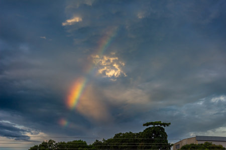 Rainbow in the sky over the city in the evening, Thailand.の写真素材