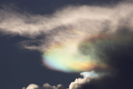 Rainbow in the dark sky with clouds.の写真素材