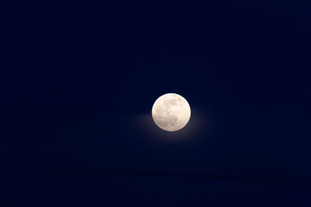Full moon in the night sky, closeup photo with selective focusの写真素材