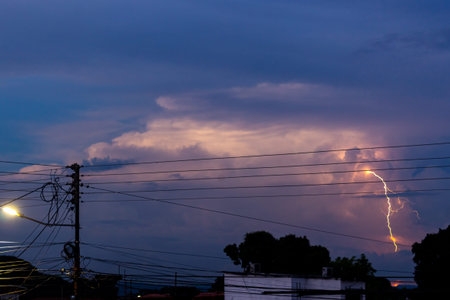 Lightning in the sky at sunset. Thunderstorm in the evening.