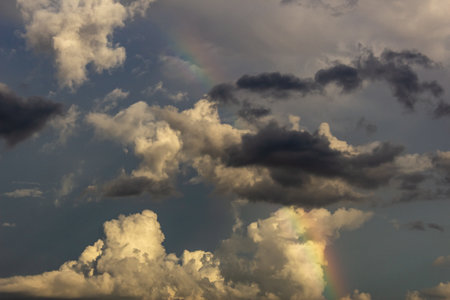 Cloudscape has been developing in gorgeous form. The clouds have been shaped as a rainbow.の写真素材