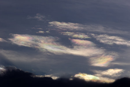 Rainbow in the sky at sunset. The sun shines through the clouds.の写真素材