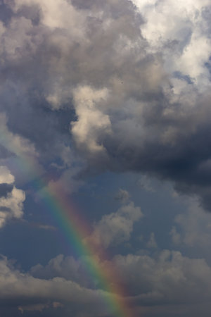 Rainbow in the sky, clouds and rainbow. Blue sky background.の写真素材