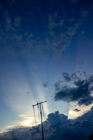 Silhouette of a crane against the blue sky with clouds.の写真素材