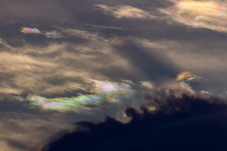 Clouds with rainbow in the evening sky, closeup of photoの写真素材