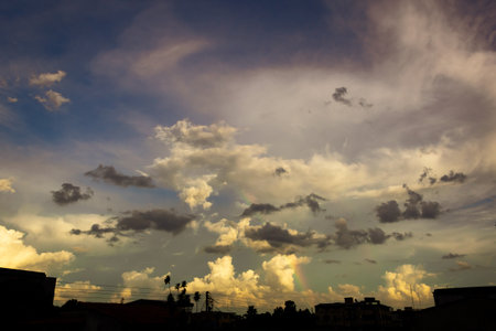 Cloudscape, Colored Clouds at Sunset near the Ocean with a Rainbowの写真素材