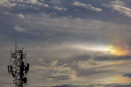 Silhouette of tower with beautiful cloud and sun.の写真素材
