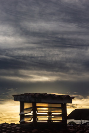 Silhouette of a structure at sunset with a dramatic skyの写真素材