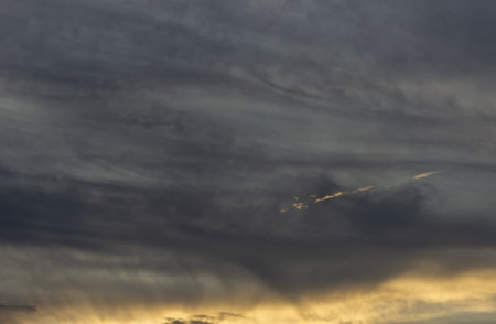 Cloudscape, Colored Clouds at Sunset near the Ocean with a Golden Light