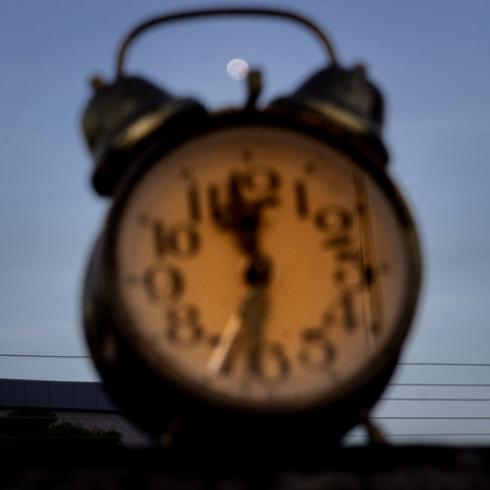 Close-up of an old fashioned alarm clock on a train stationの写真素材