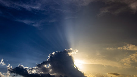 Sunset sky with clouds and sun rays. Beautiful natural background.