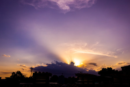 Sunset sky with clouds and silhouette of a city in Thailand.の写真素材