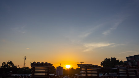 Sunset over the city. View of the roofs of the houses.の写真素材