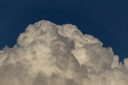 White fluffy clouds in the blue sky, natural background. Cloudscape.
