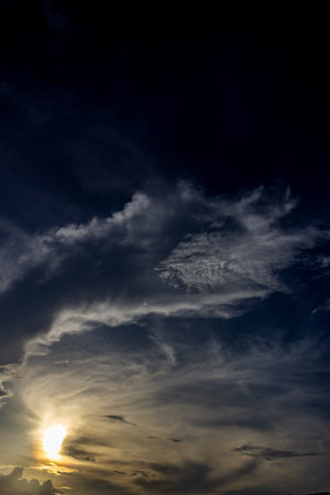 Sunset sky with clouds and sunbeams. Nature background.の写真素材