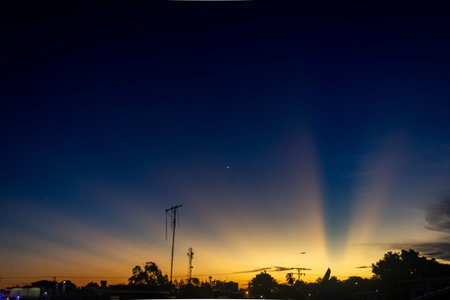 Sunset in the city. The rays of the sun make their way through the clouds.