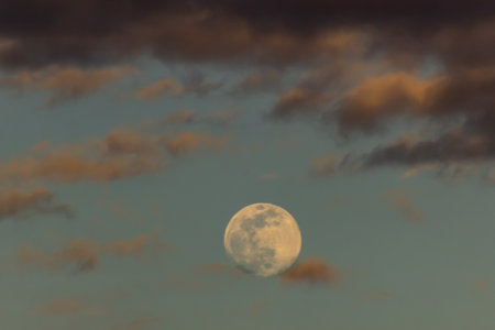 Moon in the evening sky with clouds. Nature background. Sepia tone.の写真素材