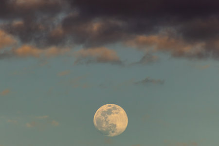 The full moon in the blue sky with clouds.の写真素材