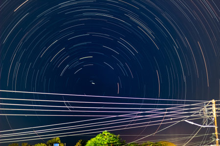 Star trails in the night sky. Long exposure photograph with grain.