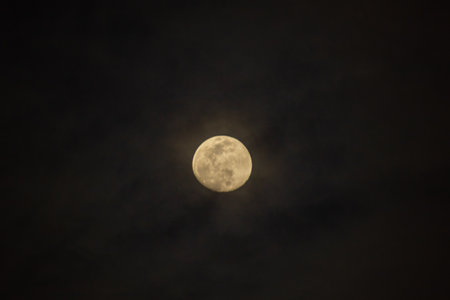 Full moon in the dark sky with clouds, natural background photo.の写真素材