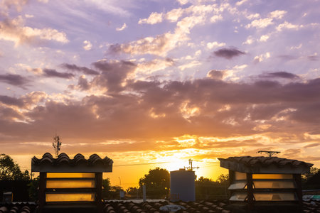 Sunset sky with clouds and silhouette of a building in the city.の写真素材