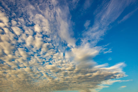 Clouds in the blue sky at sunset as an abstract background.