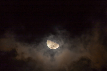 The moon in the night sky in the clouds, closeup of photo