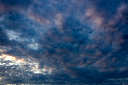 Clouds in the blue sky at sunset as an abstract background.