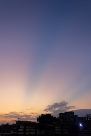 Sunset sky with clouds and the silhouette of a house in the cityの写真素材