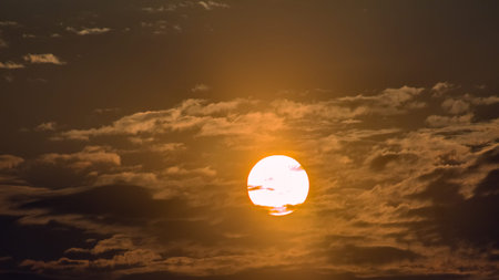 Beautiful sunset sky background with clouds and sun. Nature composition.