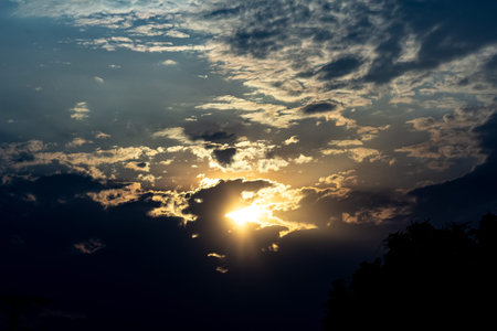Sunset sky with clouds and sunbeams. Nature background.の写真素材