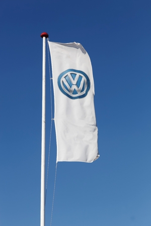 Horsens, Denmark - September 30, 2015: Volkswagen logo on a flag. Volkswagen is a german car manufacturer headquartered in Wolfsburg, Germany.のeditorial素材