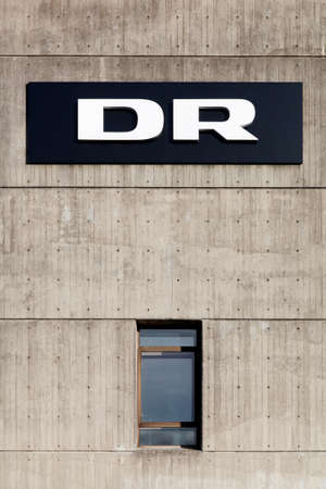 Aarhus, Denmark - November 8, 2015: DR logo on the facade of radio and television studios in Aarhus. Danmarks Radio, abbreviated DR is the danish public broadcasting company founded in 1925のeditorial素材