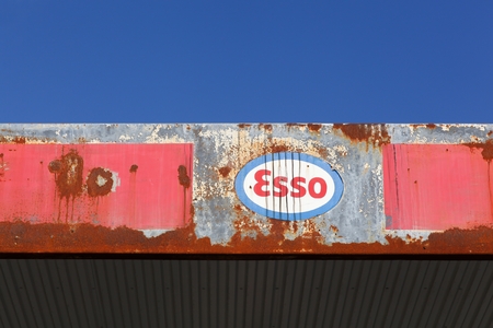 Aarhus, Denmark - October 28, 2015: Old and vintage logo of Esso on an abandoned gas station. Esso is an international gas trade name for ExxonMobil and its related companies.のeditorial素材