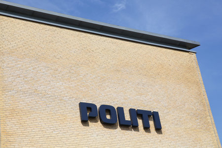 Horsens, Denmark - May 22, 2016: Danish police sign on a wall. The police of Denmark called politi in danish is the interior part of the Danish legitimate force providersのeditorial素材