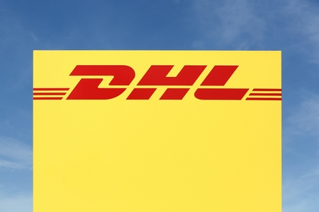 Skanderborg, Denmark - May 26, 2016: DHL logo on a panel. DHL Express is a division of the german logistics company Deutsche Post DHL providing international express mail servicesのeditorial素材