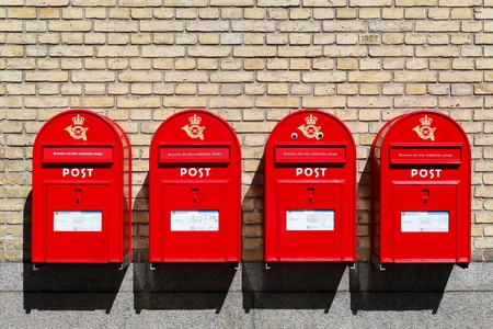 Red danish letterboxes on a wallの写真素材
