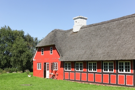 Old and traditional house in Denmark with thatched roofの写真素材