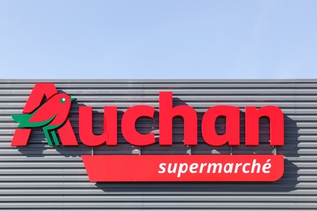 Massieux, France - March 14, 2018: Auchan supermarket on a wall. Auchan is a French international retail group and It is one of the world's principal distribution groups with a presence in 15 countriesのeditorial素材