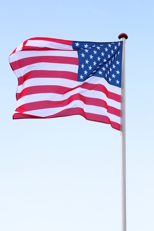 Flag of USA waving in the skyの写真素材